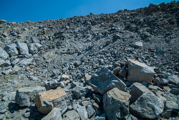 Granite open pit and stones against the sky.