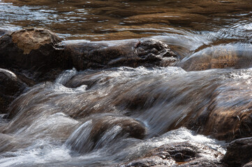 Clear water in a mountain river at a rapid.