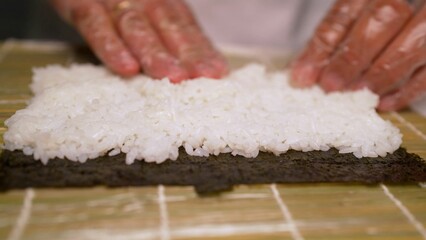 The process of making sushi and rolls. Making sushi. Production of sushi and rolls.