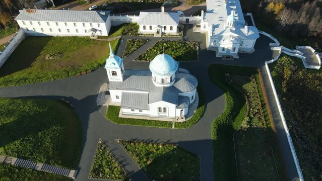 Pokrovsko-Tervenichesky monastery of the Leningrad region on the shore of the lake. Video of autumn landscape with a beautiful sunset and an Orthodox convent.