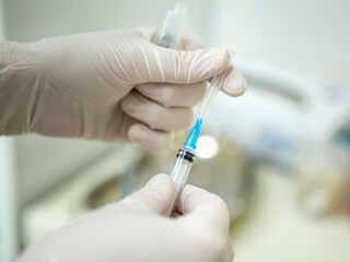 Infusion syringe in the hands of a nurse. Selective focus