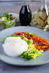 Fresh salad with burrata, lettuce and tomatoes. Delicious Italian cheese made from mozzarella and cream
