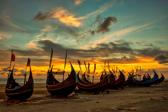 View of traditional fishing boats along the shoreline at sunset on the beach on St. Martin's Island, Teknaf, Chittagong, Bangladesh.
