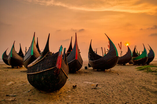 View of traditional fishing boats along the shoreline at sunset on the beach on St. Martin's Island, Teknaf, Chittagong, Bangladesh.