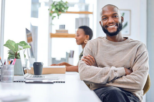 Work hard and youll surely achieve success. Portrait of a confident businessman sitting at his desk.
