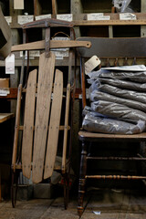 Antique Wooden Runner Sled For Sale Among Old Equipment in a General Store