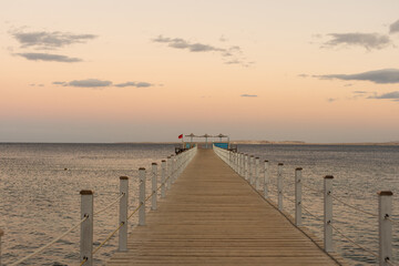 Golden sea sunset on the wooden pier.