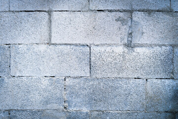 Natural gray brick texture. Concrete block wall background.