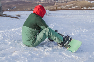 Fototapeta na wymiar Snowboarder skier novice on snow in nature
