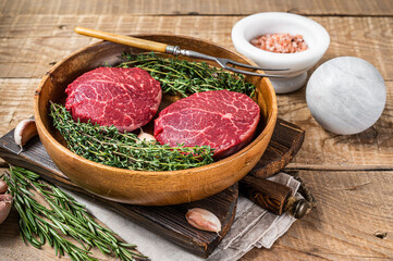 Fresh meat Fillet Mignon steaks from beef tenderloin. wooden background. Top view