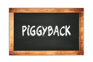 Fototapeta premium PIGGYBACK text written on wooden frame school blackboard.
