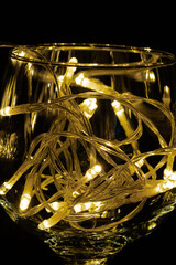 Fairy Light in a wine glass, in the Dark, Low-Key Photography.