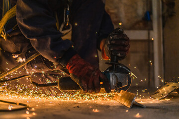 closeup of sparks caused by worker welding metal