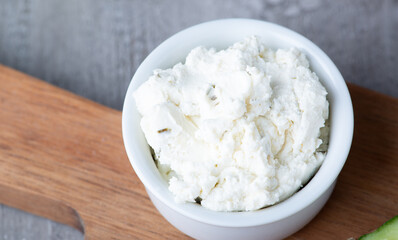 Bowl with fresh cottage cheese on tableBowl with fresh cottage cheese on table.
