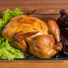 Homemade grilled whole baked chicken with lettuce. View from above