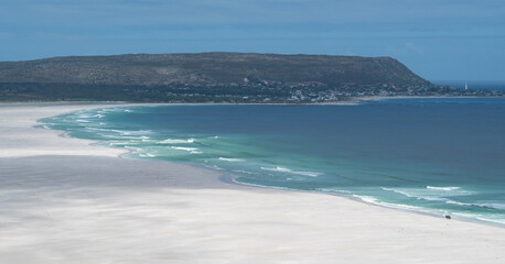 Two isolated horse riders on Noordhoek, Long Beach, South Africa.