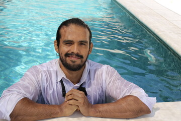 Seductive elegant ethnic man in swimming pool