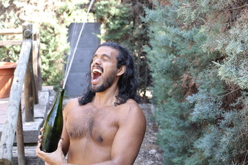 Muscular shirtless ethnic man opening champagne bottle