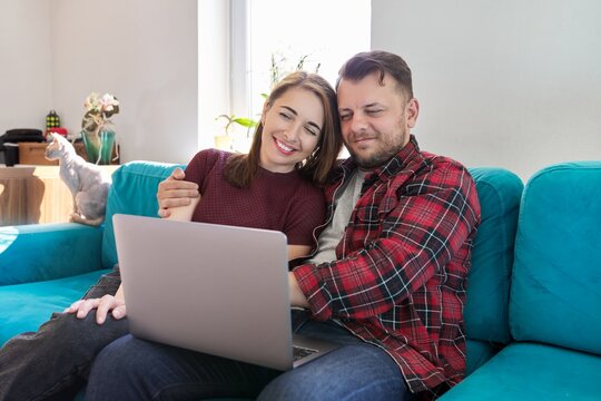 Happy Smiling Middle Aged Family Couple Looking At Laptop Screen Together