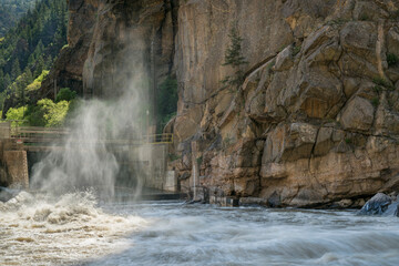 Fototapeta na wymiar Colorado River flowing from an open gate of Shoshone Power Plant in Glenwood Canyon