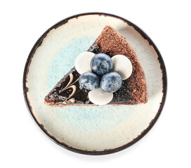 Plate with delicious piece of chocolate cake and blueberries on white background