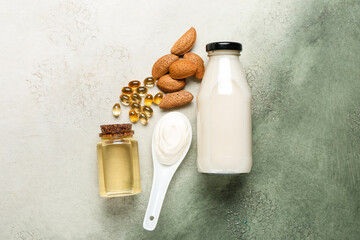 Composition with bottle of essential oil, pills and products on color background
