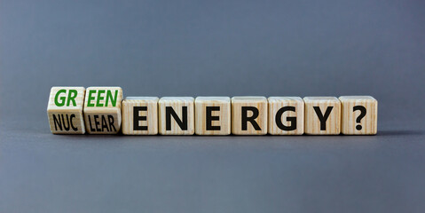 Nuclear or green energy symbol. Turned wooden cubes and changed concept words nuclear energy to...