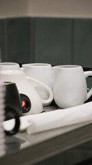 black white glasses upside down on a shelf in a coffee shop 