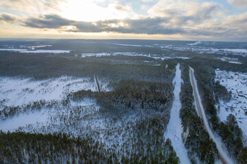 aerial view forest tundra taiga road in the forest in winter on a sunny frosty day in siberia small village. High quality photo