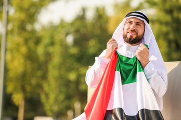 Handsome Muslim man with UAE flag outdoors