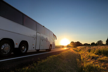 Bus with passengers on their way to vacation at sunset