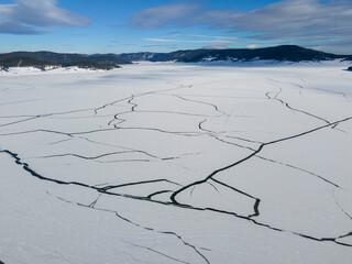Aerial winter view of Batak Reservoir covered with ice, Bulgaria