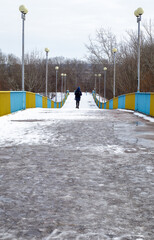 Pedestrian bridge in Chernihiv across the Desna river in the snow on a winter snowy day.