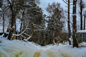 country winter landscape with the image of a village road