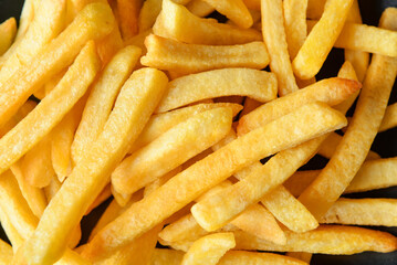 Tasty french fries as background, closeup