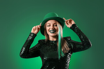 Beautiful woman in hat on green background. St. Patrick's Day celebration