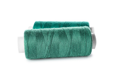 Green sewing threads on white background