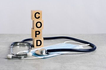 word copd is made of wooden cubes with stethoscope and medicine mask. medical concept of prevention, treatment and side effects - obrazy, fototapety, plakaty