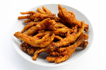 Fried chicken feet in plate on white background.