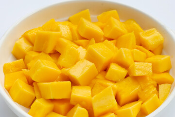 Tropical fruit, Mango cube slices in white bowl on white background.