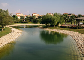 New Cairo, Egypt - 11.21.2021: Beautiful luxury living in Egypt, villas greens and artificial lake
