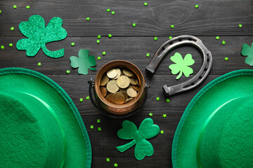 Leprechaun pot with golden coins, hats and horseshoe on dark wooden background. St. Patrick's Day...