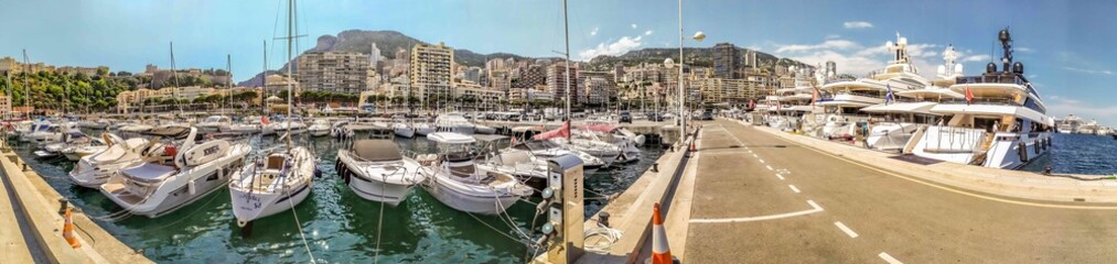 Fototapeta na wymiar White yachts. Rich life. Yachting as a hobby. Water transport. Harbor in Monte Carlo. French Riviera. Holidays in Monaco. Luxury and wealth. Live in grand style. Life style.