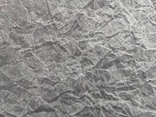 Naklejka premium gray background of crumpled paper