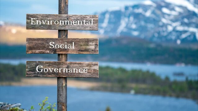 environmental social governance text quote on wooden signpost outdoors in nature. Slow pan and zoom 4k video footage.