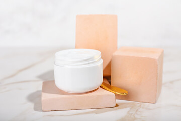 Jar with natural cosmetic cream on light background