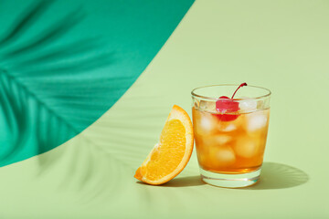 Glass of delicious Old Fashioned Cocktail on color background
