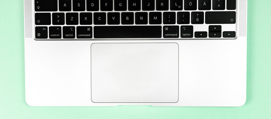 Modern laptop keyboard flat lay bright banner background. Office workplace table, minimal design concept. Top view, copy space photo