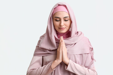 Muslim woman praying on white background