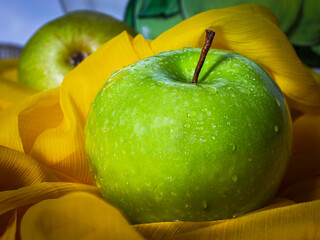 Green apple on the yellow cloth 
